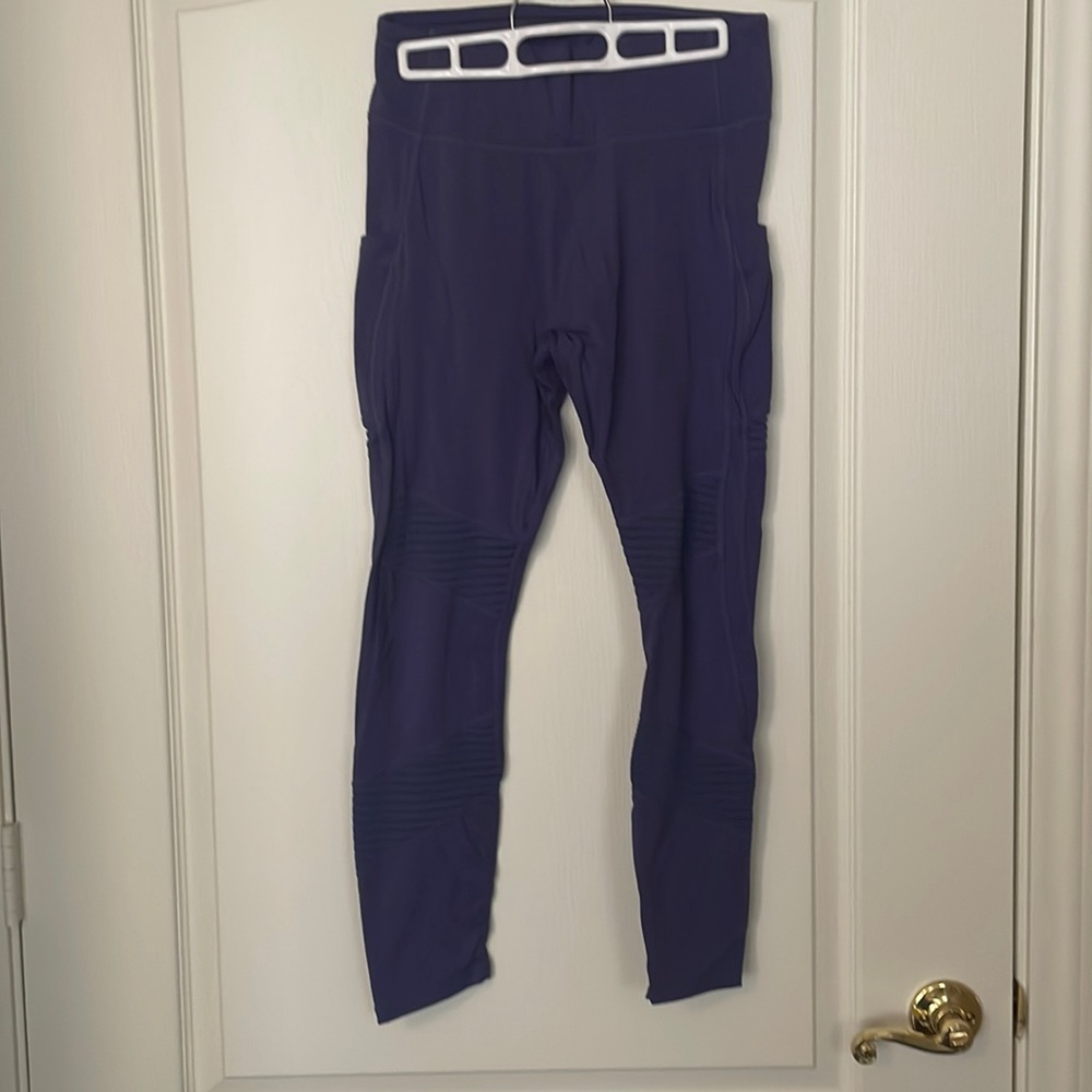 Purple work out pants with details on legs.